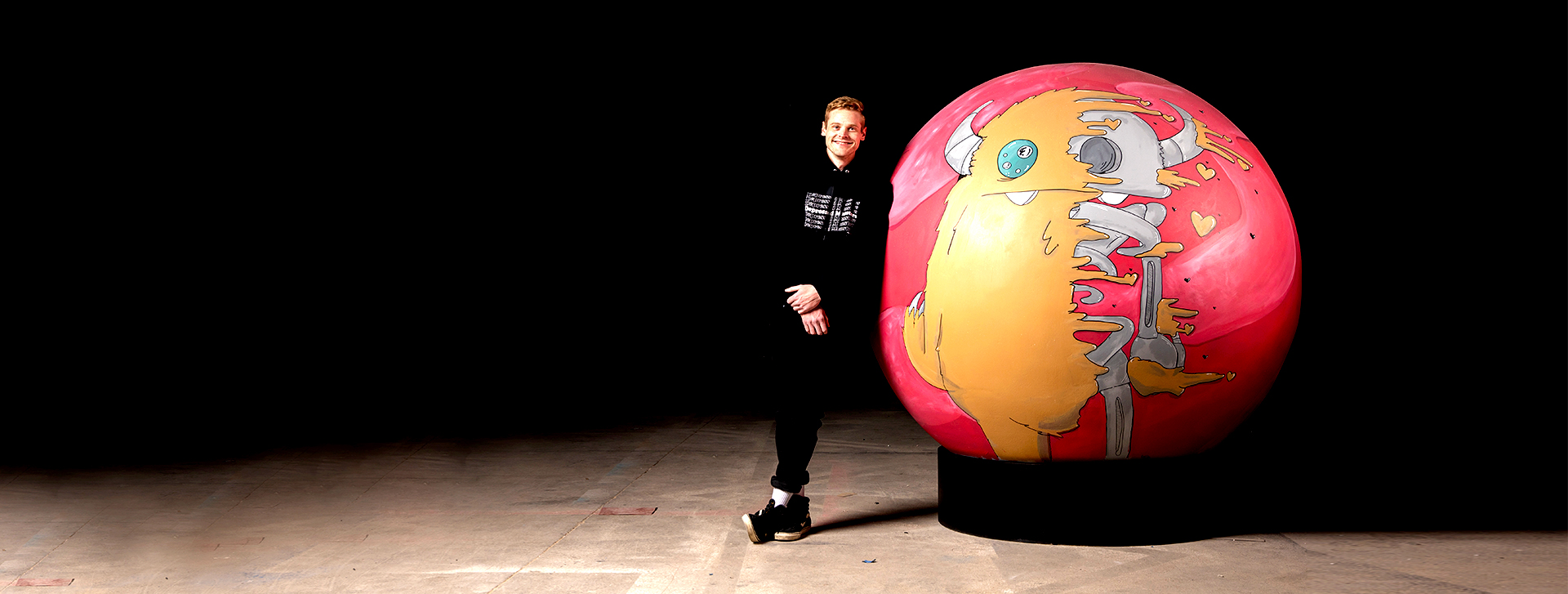 young man with giant bingo ball