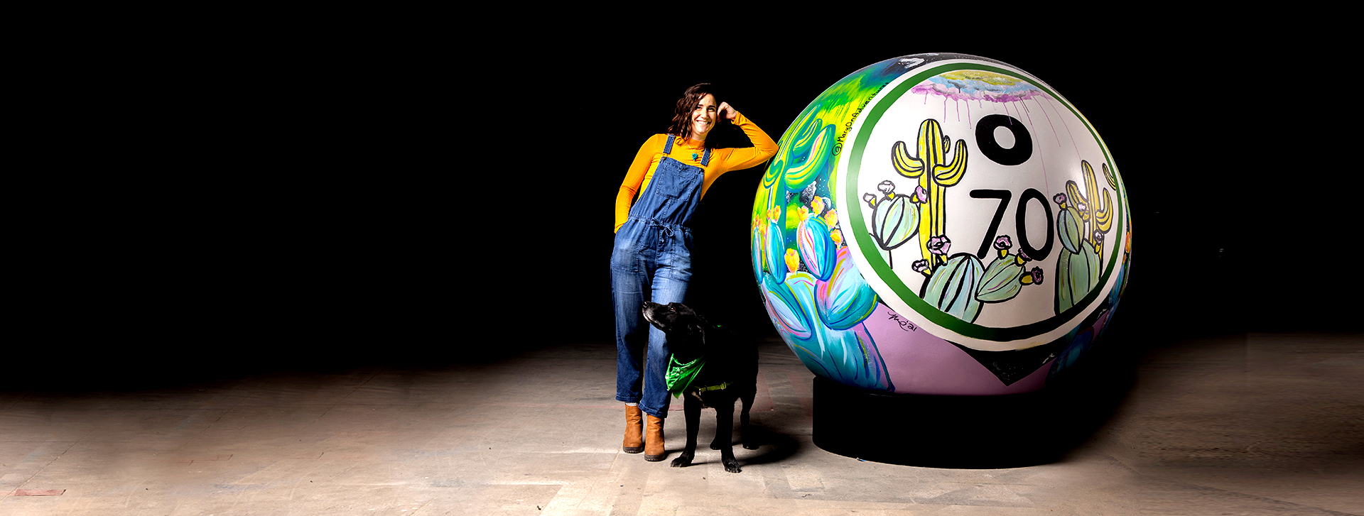 woman and dog with giant bingo ball